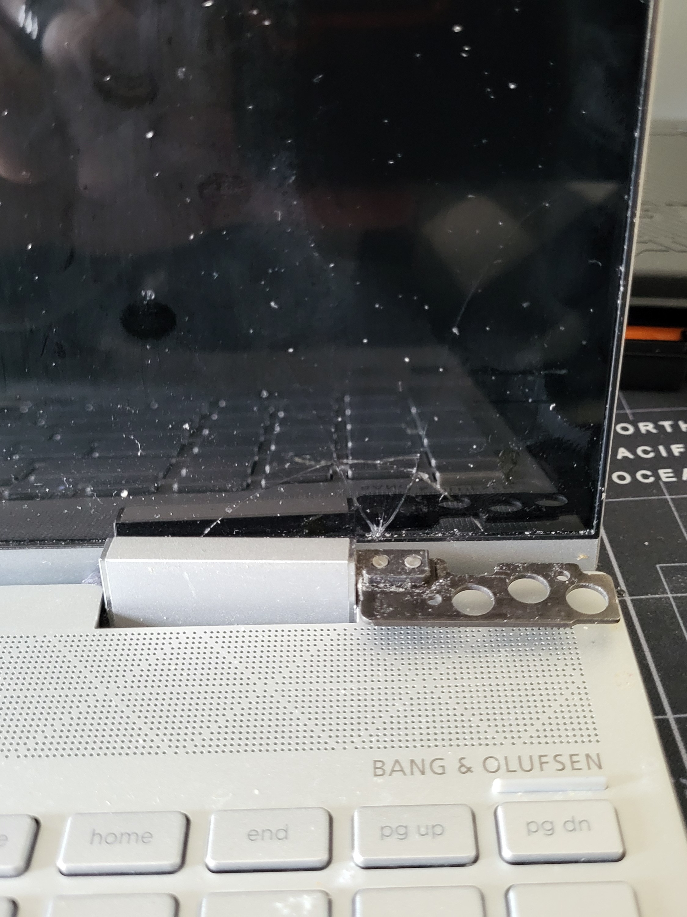 A laptop with the display and hinge display broken.